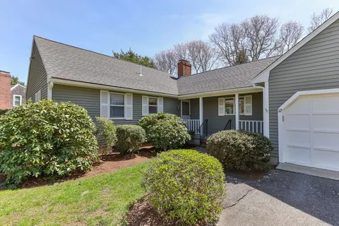 a front view of house with yard and outdoor seating