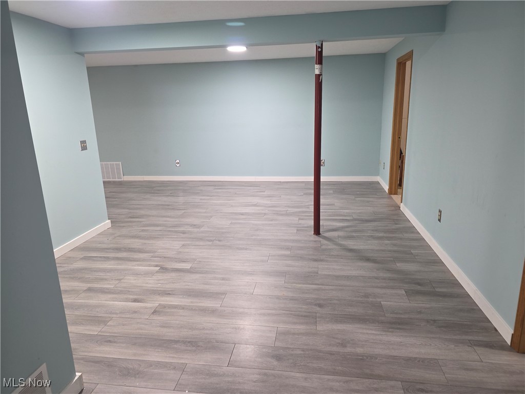 2291 Armstrong Road Wooster, OH 44691 - Photo 19 of 23 Finished basement featuring light wood-vinyl flooring and baseboards