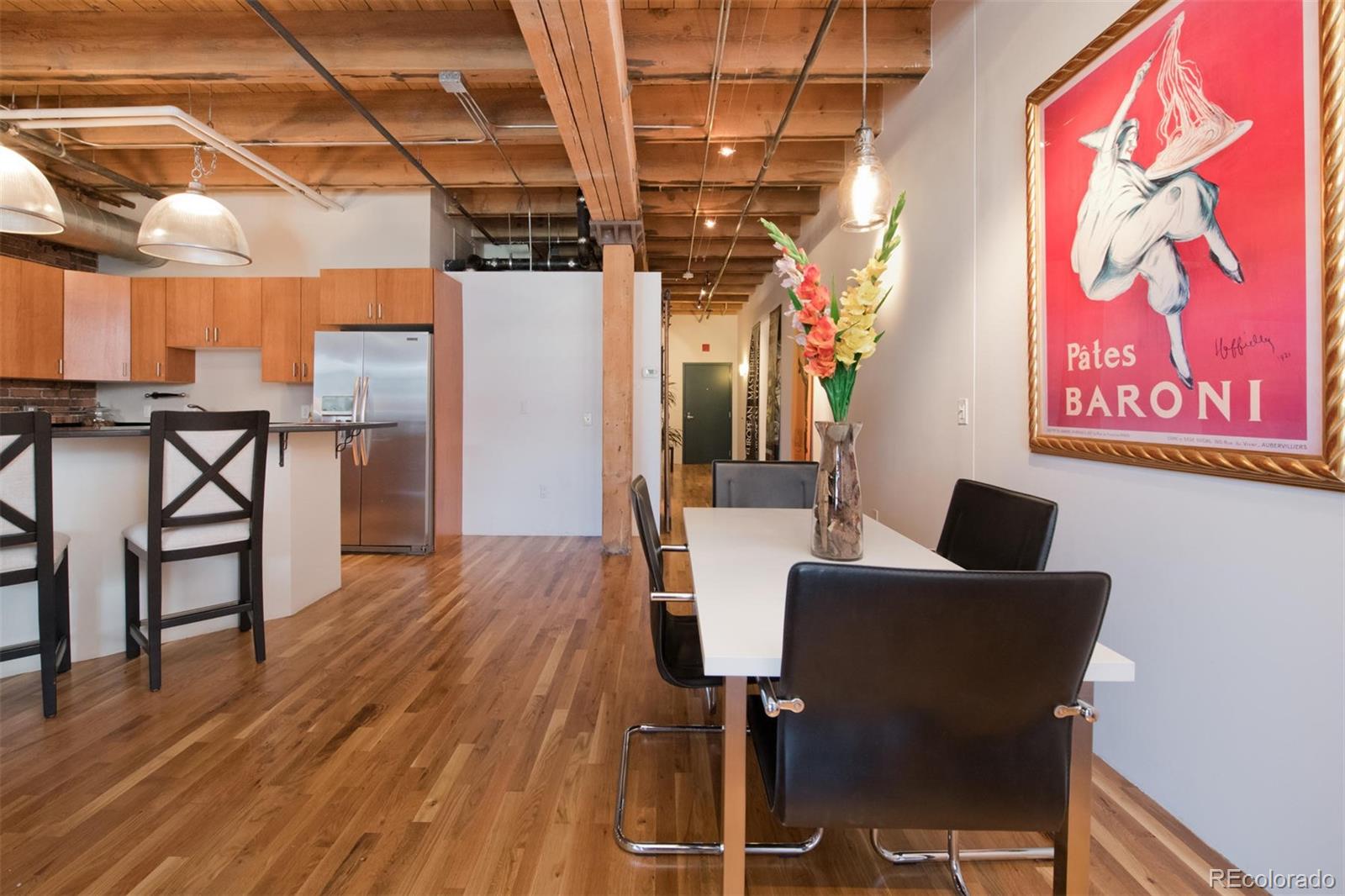 1801 Wynkoop Street, Unit 418 Denver, CO 80202 - Photo 17 of 35 a view of a dining room with furniture and wooden floor