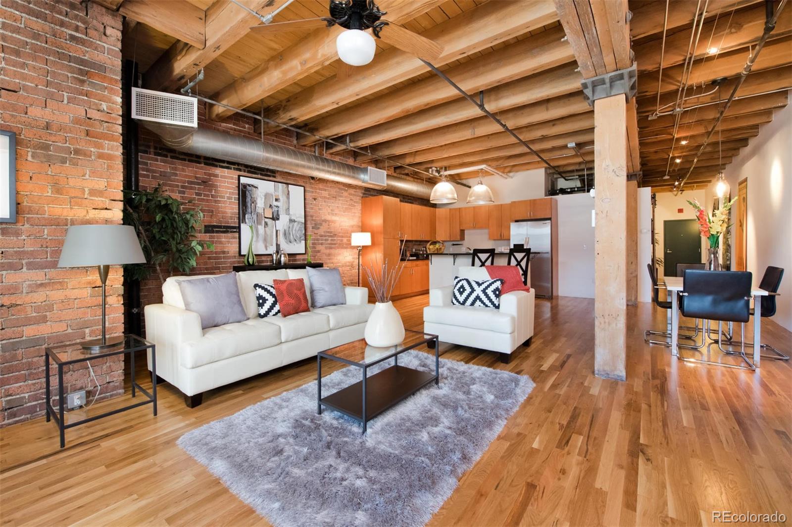 1801 Wynkoop Street, Unit 418 Denver, CO 80202 - Photo 19 of 35 a living room with furniture and a wooden floor