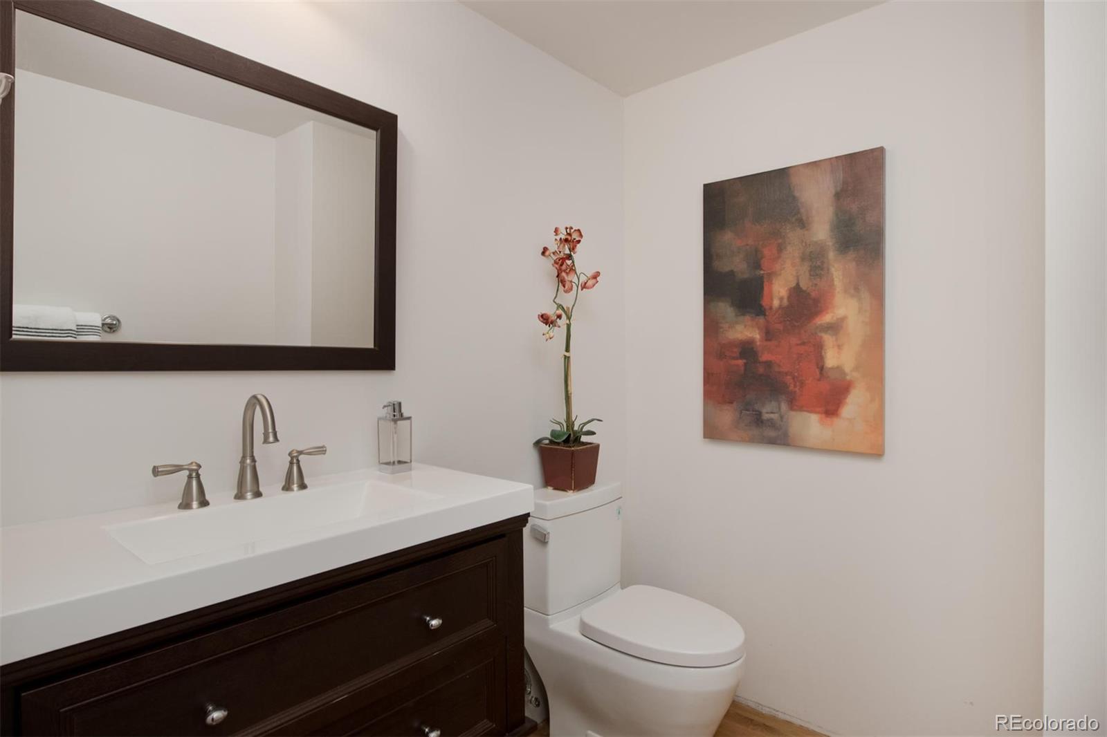 1801 Wynkoop Street, Unit 418 Denver, CO 80202 - Photo 26 of 35 a bathroom with a toilet sink and mirror