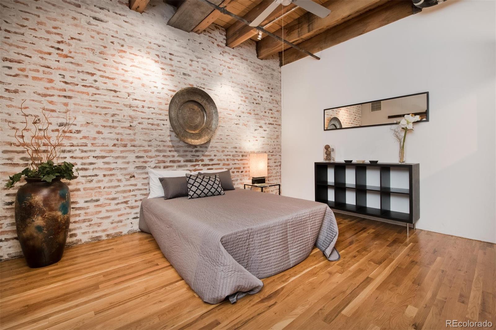 1801 Wynkoop Street, Unit 418 Denver, CO 80202 - Photo 27 of 35 a bedroom with a bed and a table