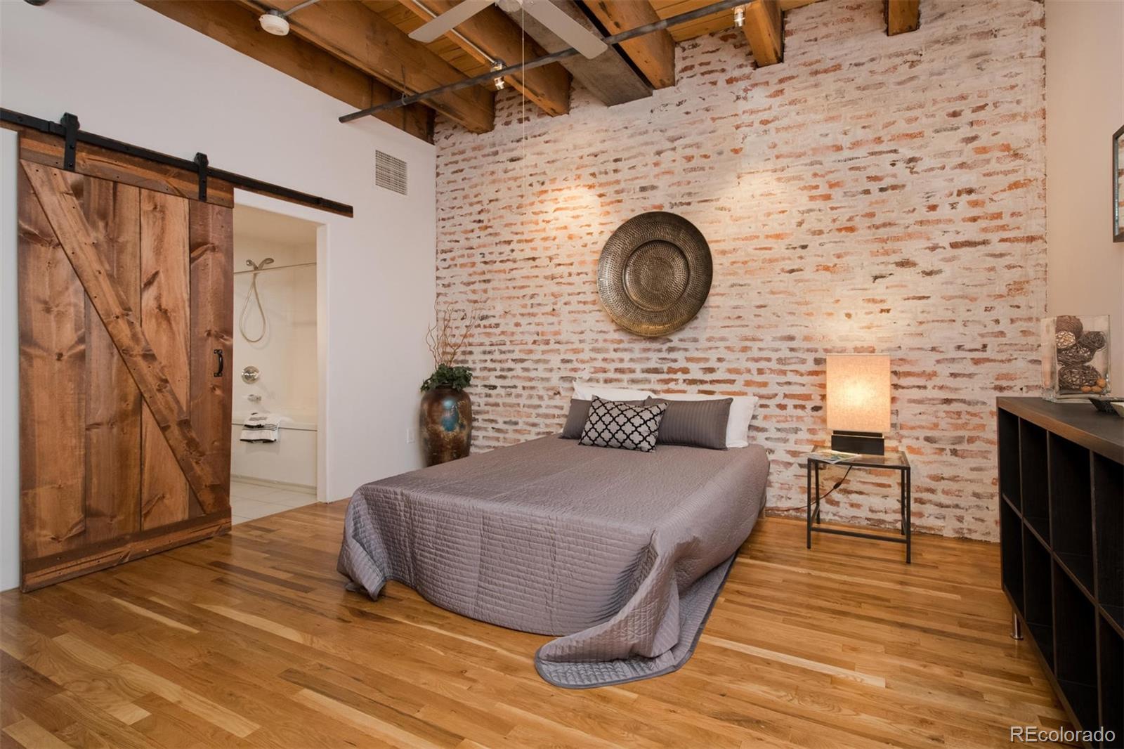 1801 Wynkoop Street, Unit 418 Denver, CO 80202 - Photo 30 of 35 a living room with a wooden floor and a fireplace