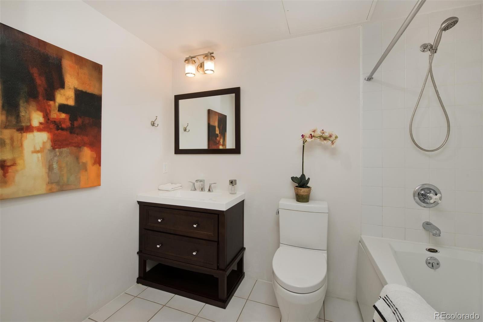 1801 Wynkoop Street, Unit 418 Denver, CO 80202 - Photo 32 of 35 a bathroom with a toilet sink and mirror