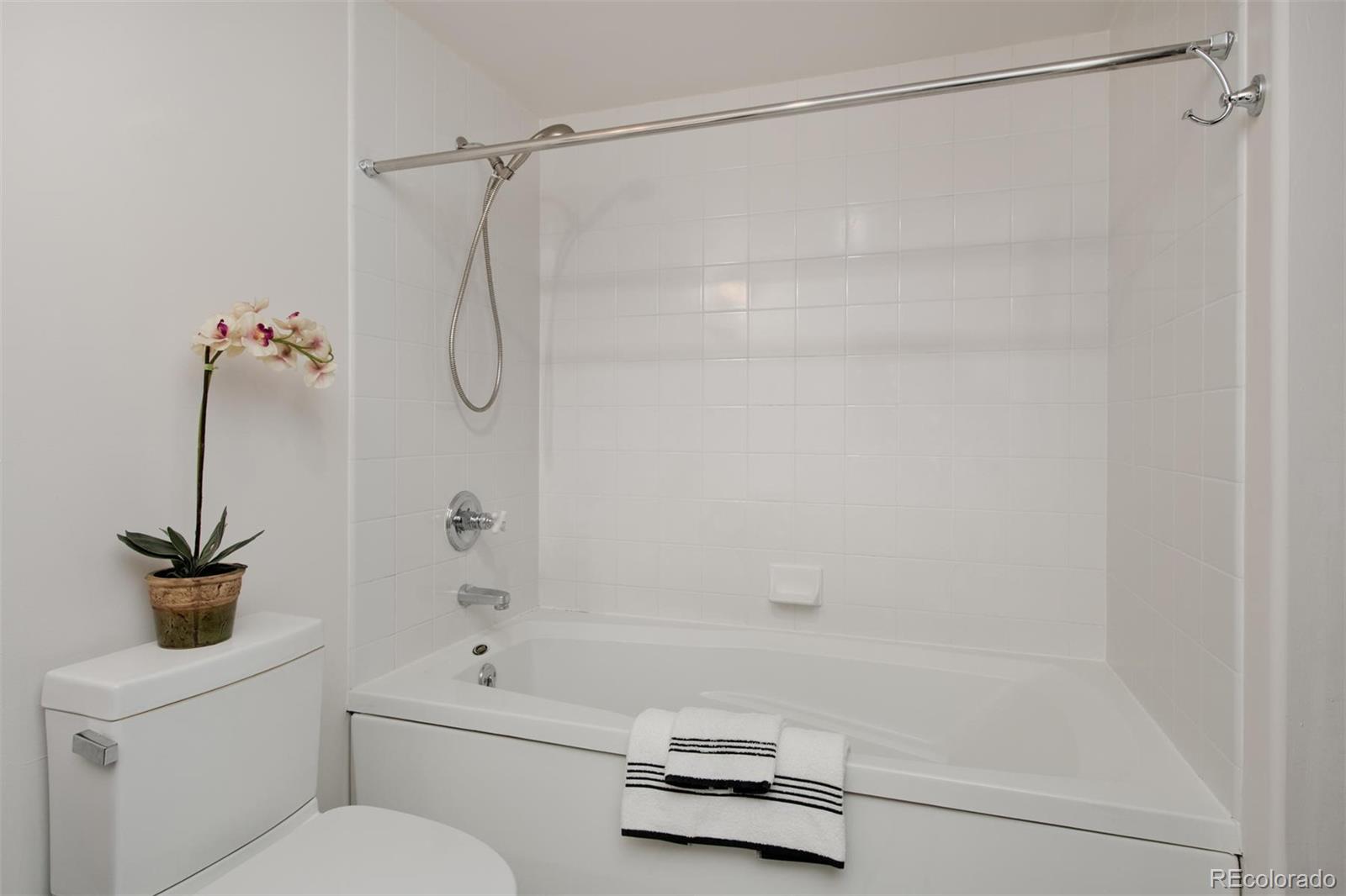 1801 Wynkoop Street, Unit 418 Denver, CO 80202 - Photo 34 of 35 a bathroom with a shower a toilet and a shower