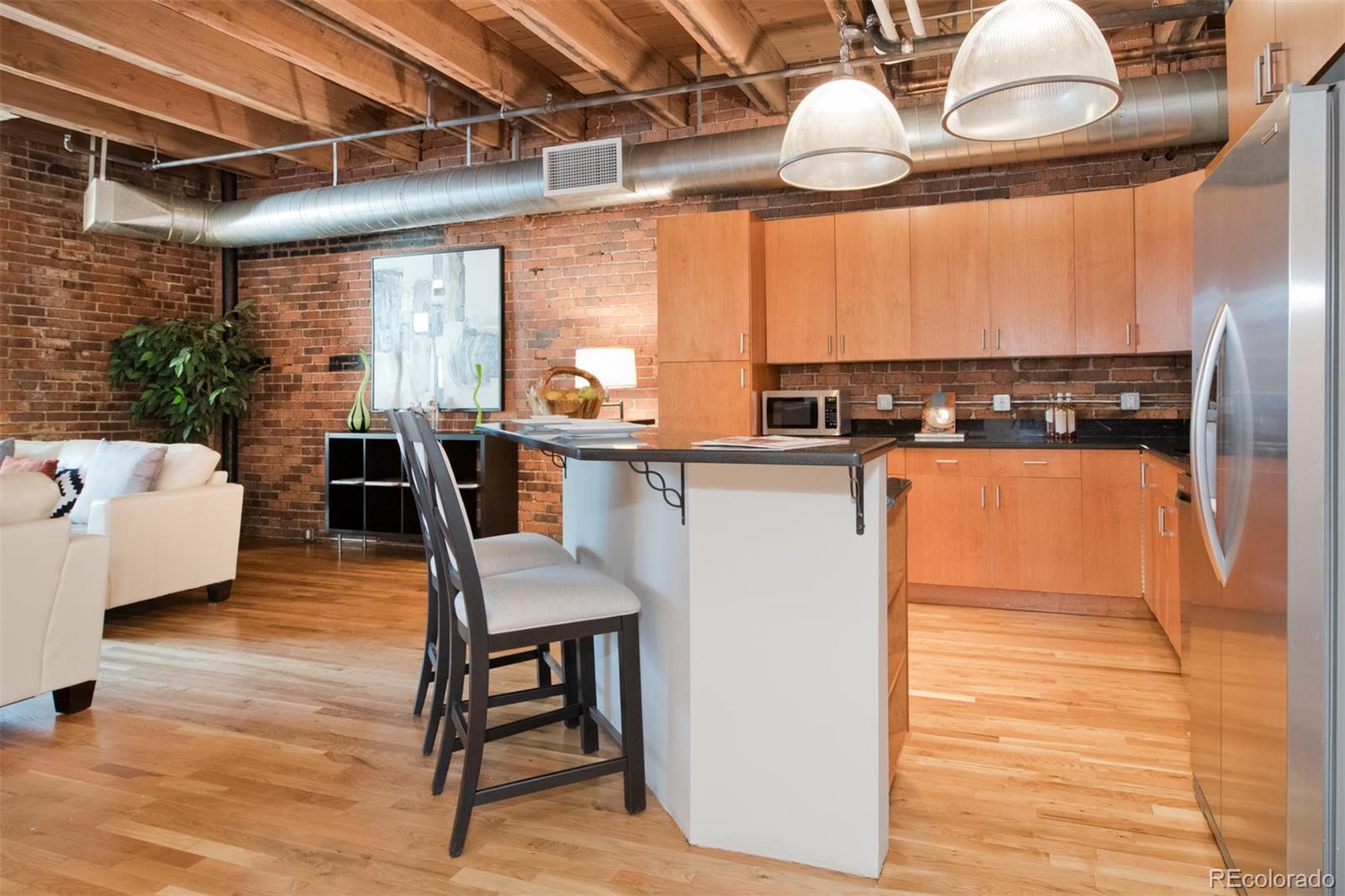 1801 Wynkoop Street, Unit 418 Denver, CO 80202 - Photo 7 of 35 a dining room with wooden floor and large windows