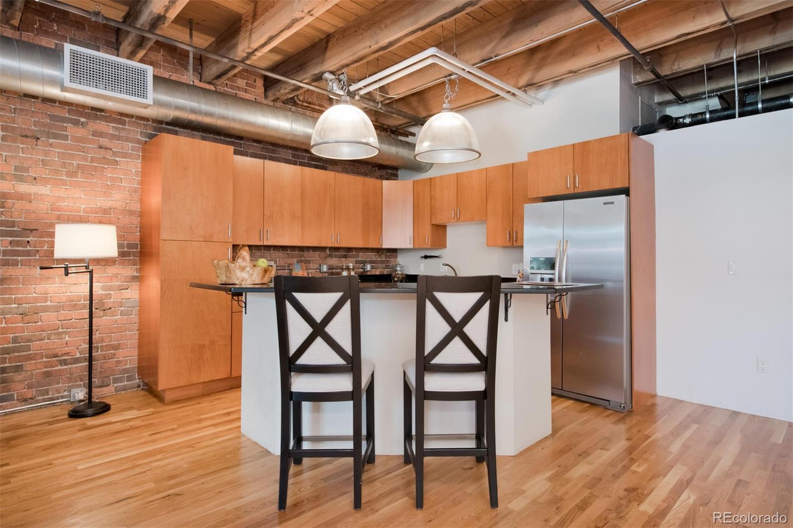 1801 Wynkoop Street, Unit 418 Denver, CO 80202 - Photo 8 of 35 a view of a kitchen with a table and chairs