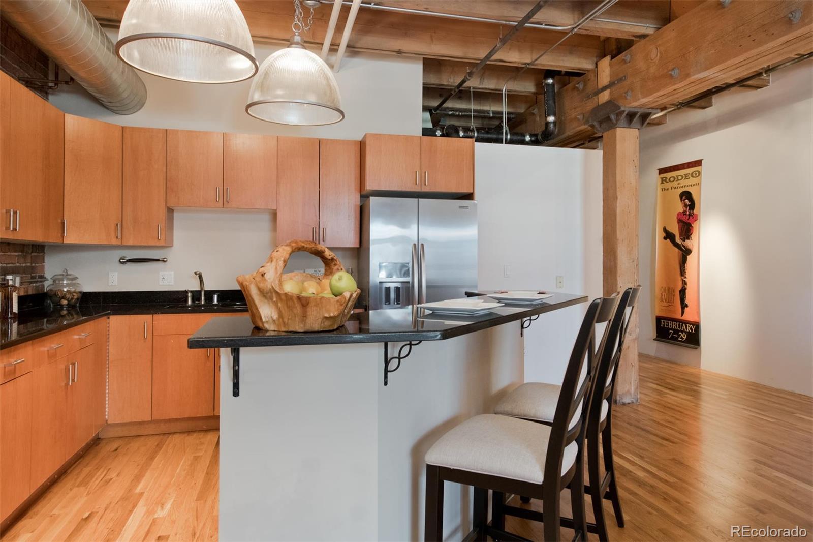 1801 Wynkoop Street, Unit 418 Denver, CO 80202 - Photo 9 of 35 a kitchen with stainless steel appliances granite countertop a sink dishwasher a stove a refrigerator with a dining table and chairs with wooden floor