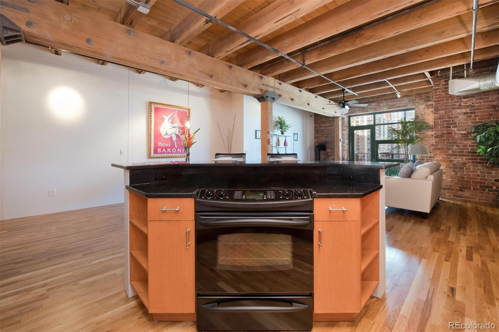 1801 Wynkoop Street, Unit 418 Denver, CO 80202 - Photo 10 of 35 a kitchen with granite countertop a stove and cabinets