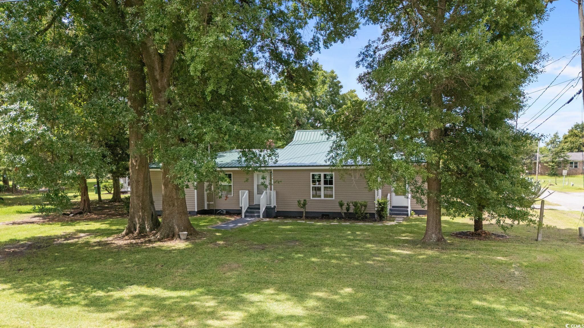 1821 Hawkins Street Georgetown, SC 29440 - Photo 11 of 40 View of front of home with a metal roof, a front lawn, and entry steps