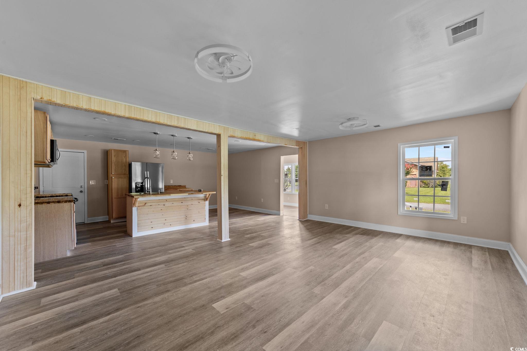 1821 Hawkins Street Georgetown, SC 29440 - Photo 19 of 40 Unfurnished living room featuring wood finished floors