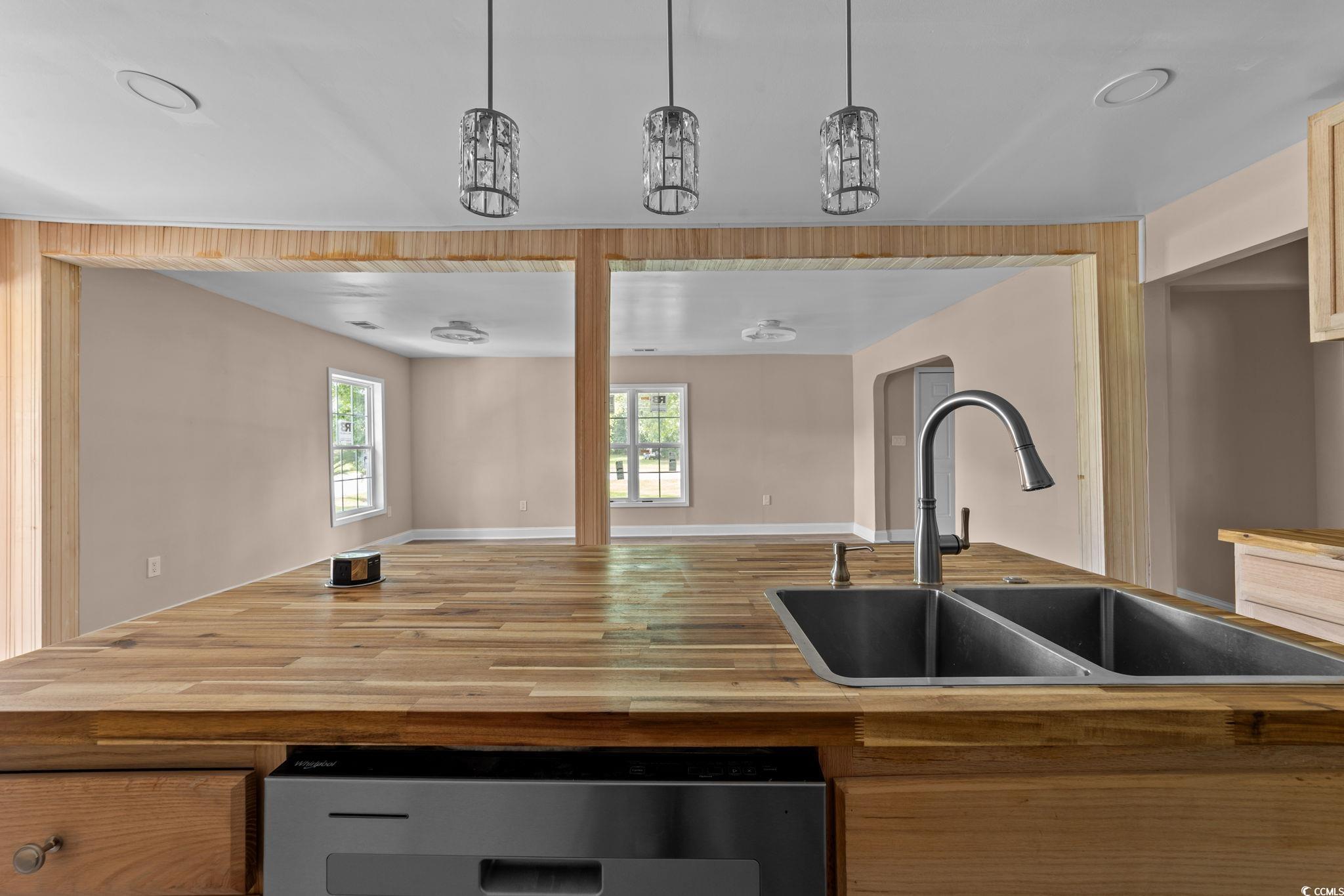 1821 Hawkins Street Georgetown, SC 29440 - Photo 40 of 40 Kitchen with wooden counters, open floor plan, dishwasher, wood finished floors, and decorative light fixtures