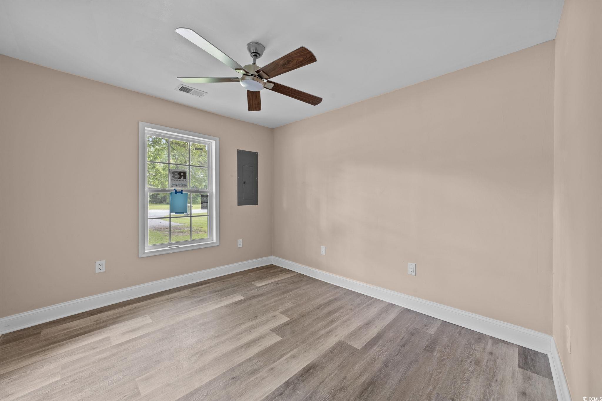 1821 Hawkins Street Georgetown, SC 29440 - Photo 28 of 40 Empty room with wood finished floors, ceiling fan, and electric panel
