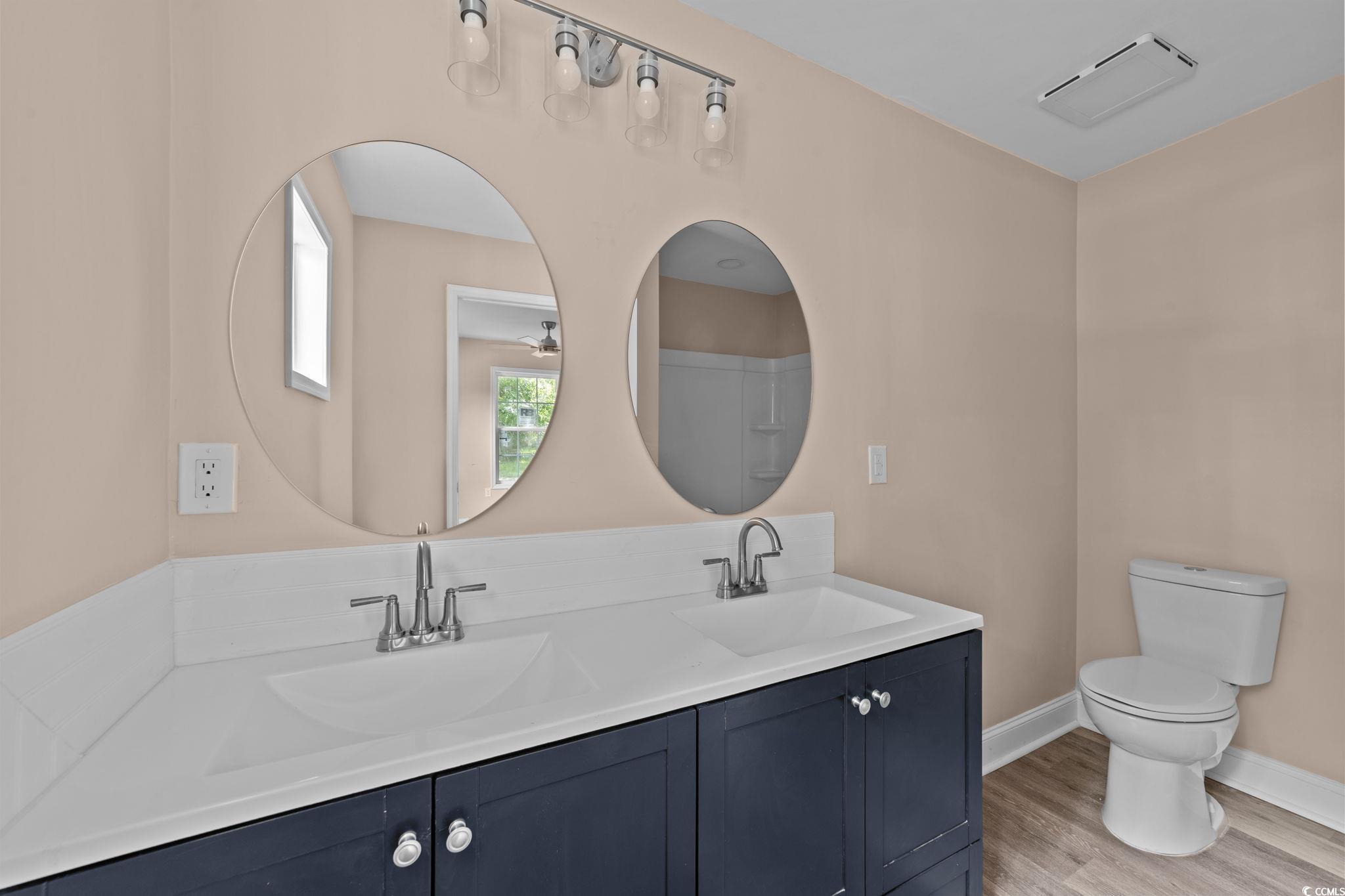 1821 Hawkins Street Georgetown, SC 29440 - Photo 33 of 40 Bathroom with double vanity and wood finished floors