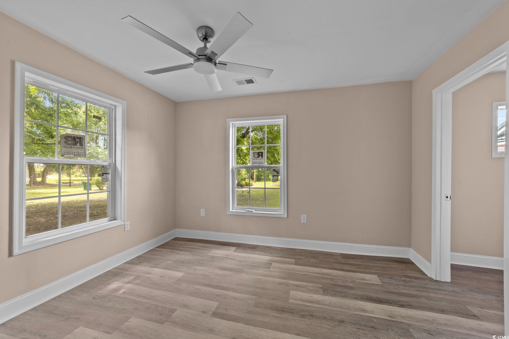 1821 Hawkins Street Georgetown, SC 29440 - Photo 35 of 40 Empty room with light wood-style flooring and a ceiling fan