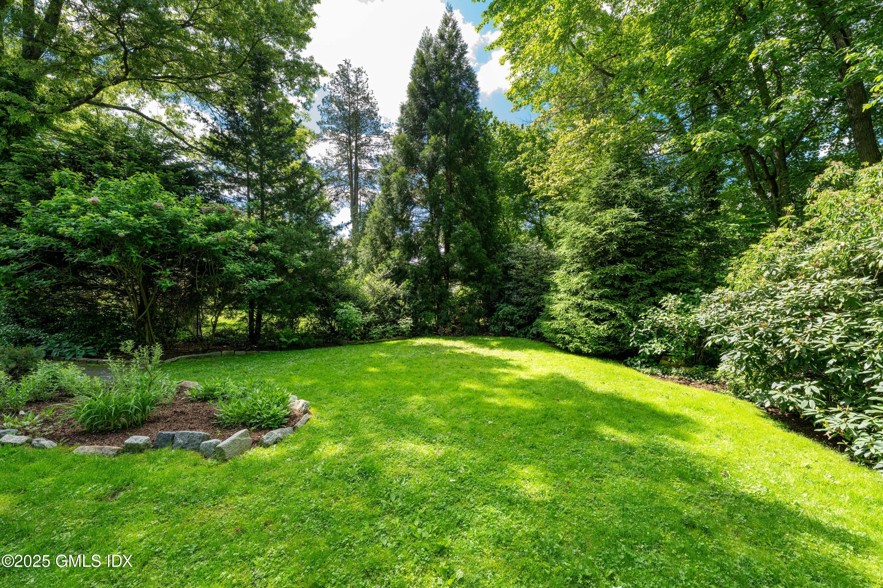 76 Sinawoy Road Cos Cob, CT 06807 - Photo 3 of 23 a view of a lush green space