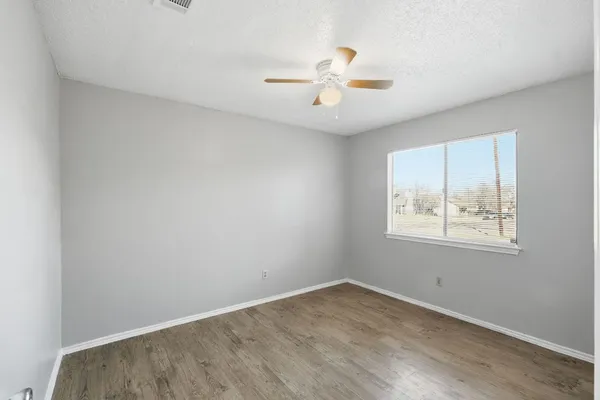 wooden floor in an empty room with a window