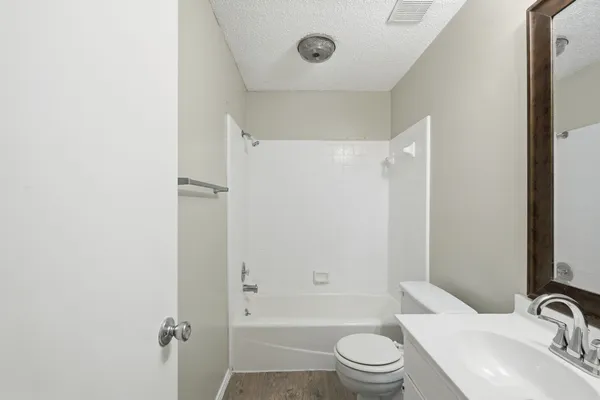 a bathroom with a sink a toilet and a tub