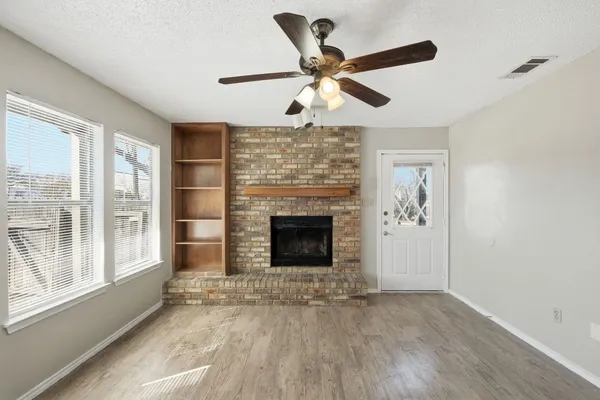 a living room with a fireplace and a window