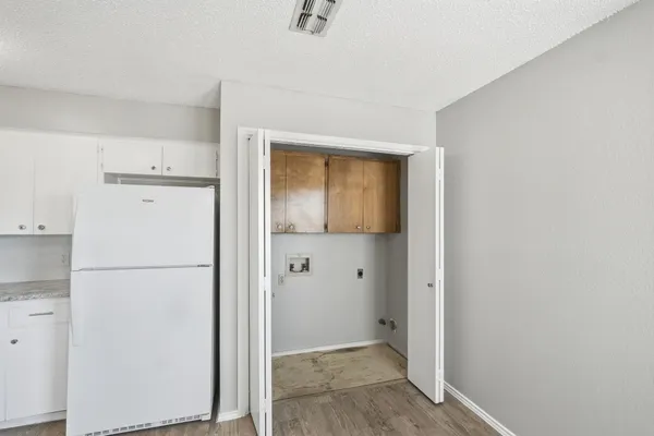a view of a kitchen with a refrigerator and a sink