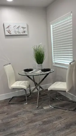 a view of a workspace with furniture and a window