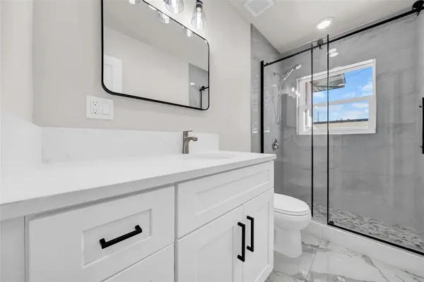 a bathroom with a sink toilet and shower