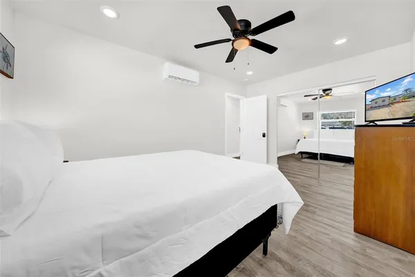 a bedroom with a bed and a chandelier