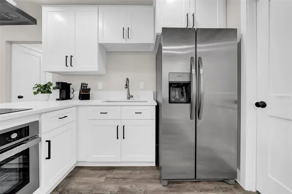 a kitchen with stainless steel appliances a refrigerator sink and cabinets