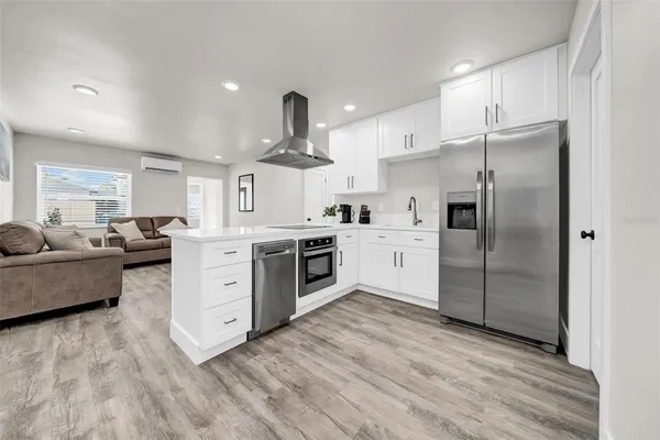 a kitchen with stainless steel appliances a refrigerator sink and cabinets