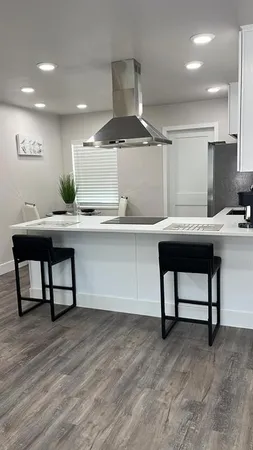 a room with a table chairs and wooden floor