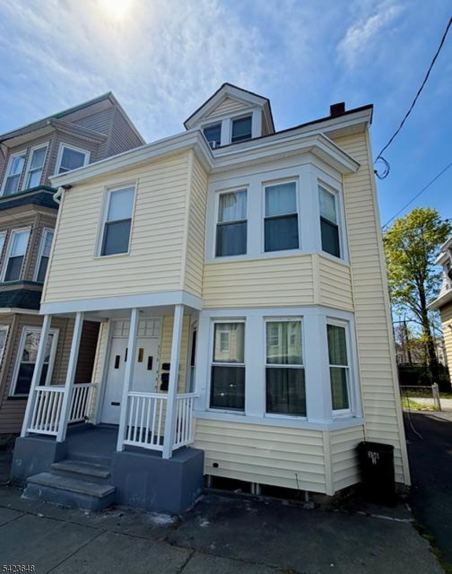 356 Pacific Street, Unit 3 Paterson, NJ 07503 - Photo 1 of 11 a front view of a house with a porch