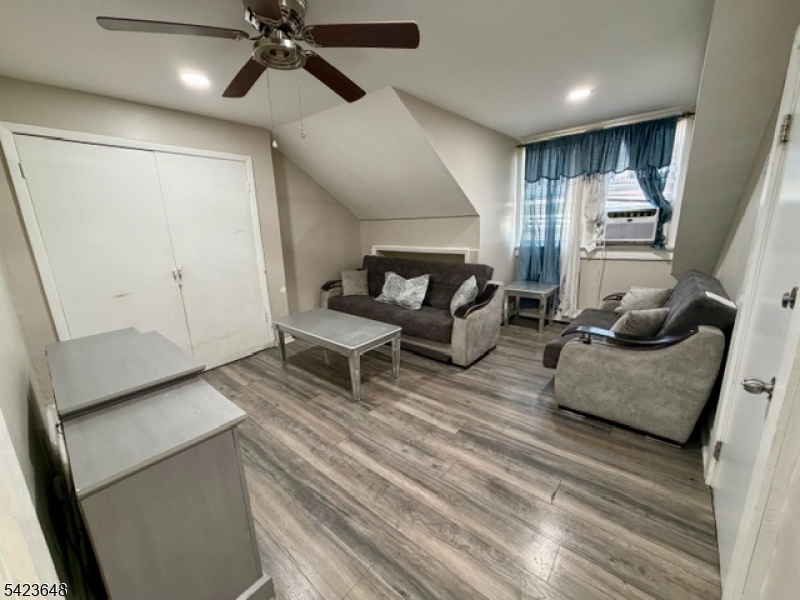356 Pacific Street, Unit 3 Paterson, NJ 07503 - Photo 2 of 11 a living room with furniture and a ceiling fan