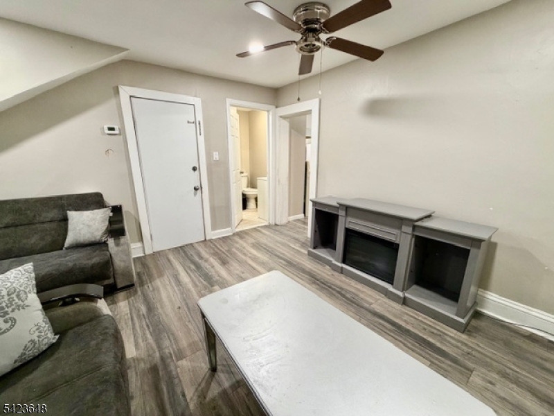 356 Pacific Street, Unit 3 Paterson, NJ 07503 - Photo 4 of 11 a living room with furniture and a fireplace