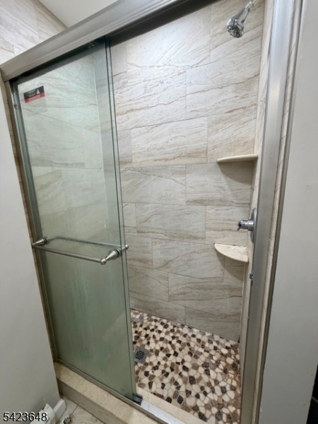 356 Pacific Street, Unit 3 Paterson, NJ 07503 - Photo 6 of 11 a bathroom with a glass shower door