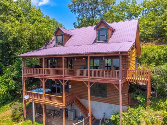a view of a house with a yard and balcony