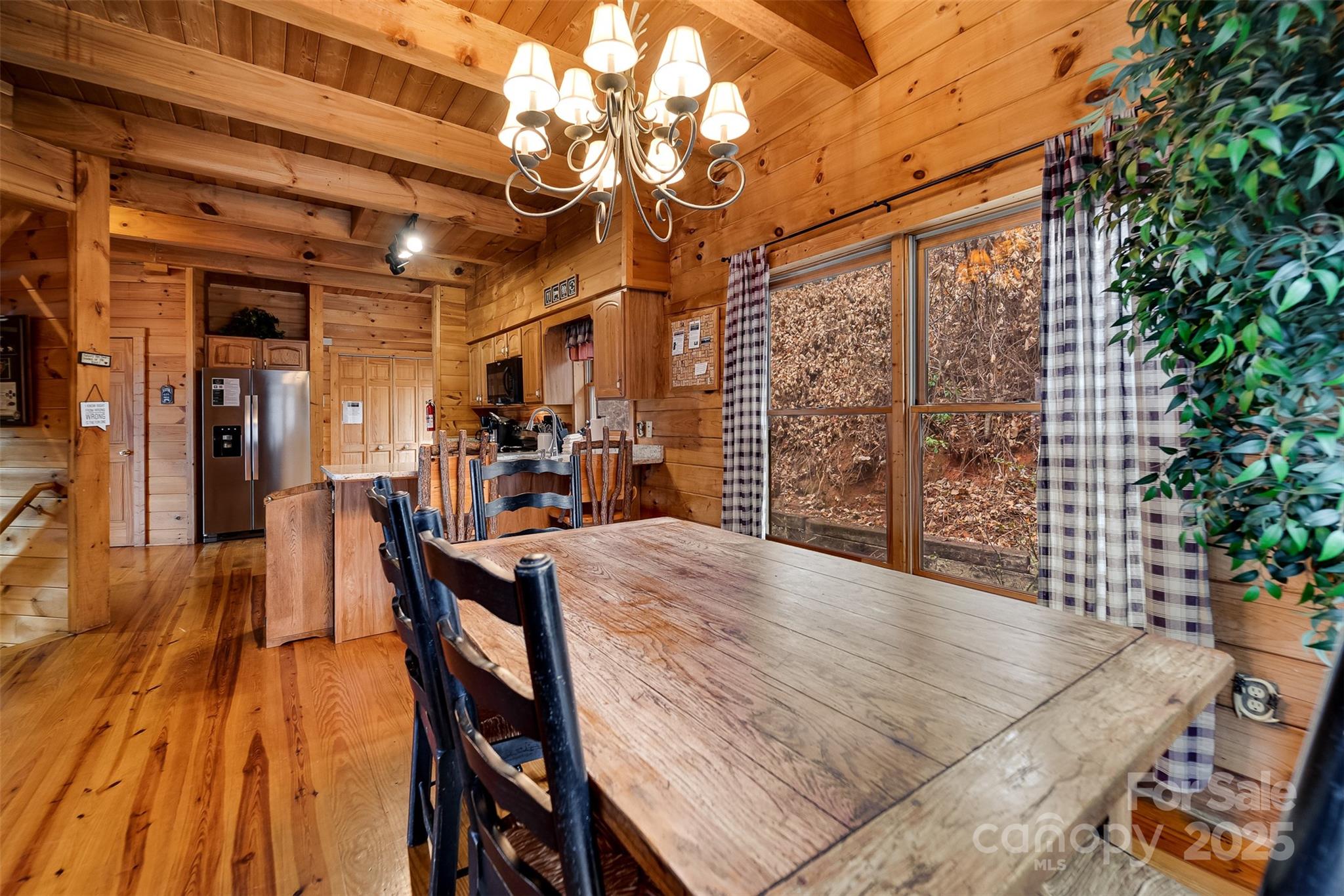 561 Signal Ridge Sylva, NC 28779 - Photo 15 of 48 a view of a patio with dining table and chairs with wooden floor and fence