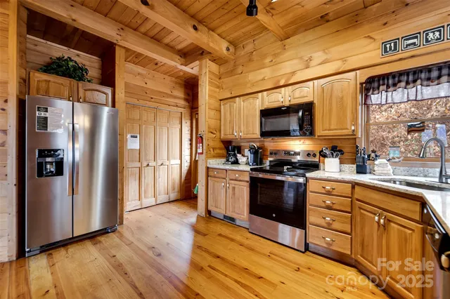 a kitchen with stainless steel appliances granite countertop a refrigerator stove and sink