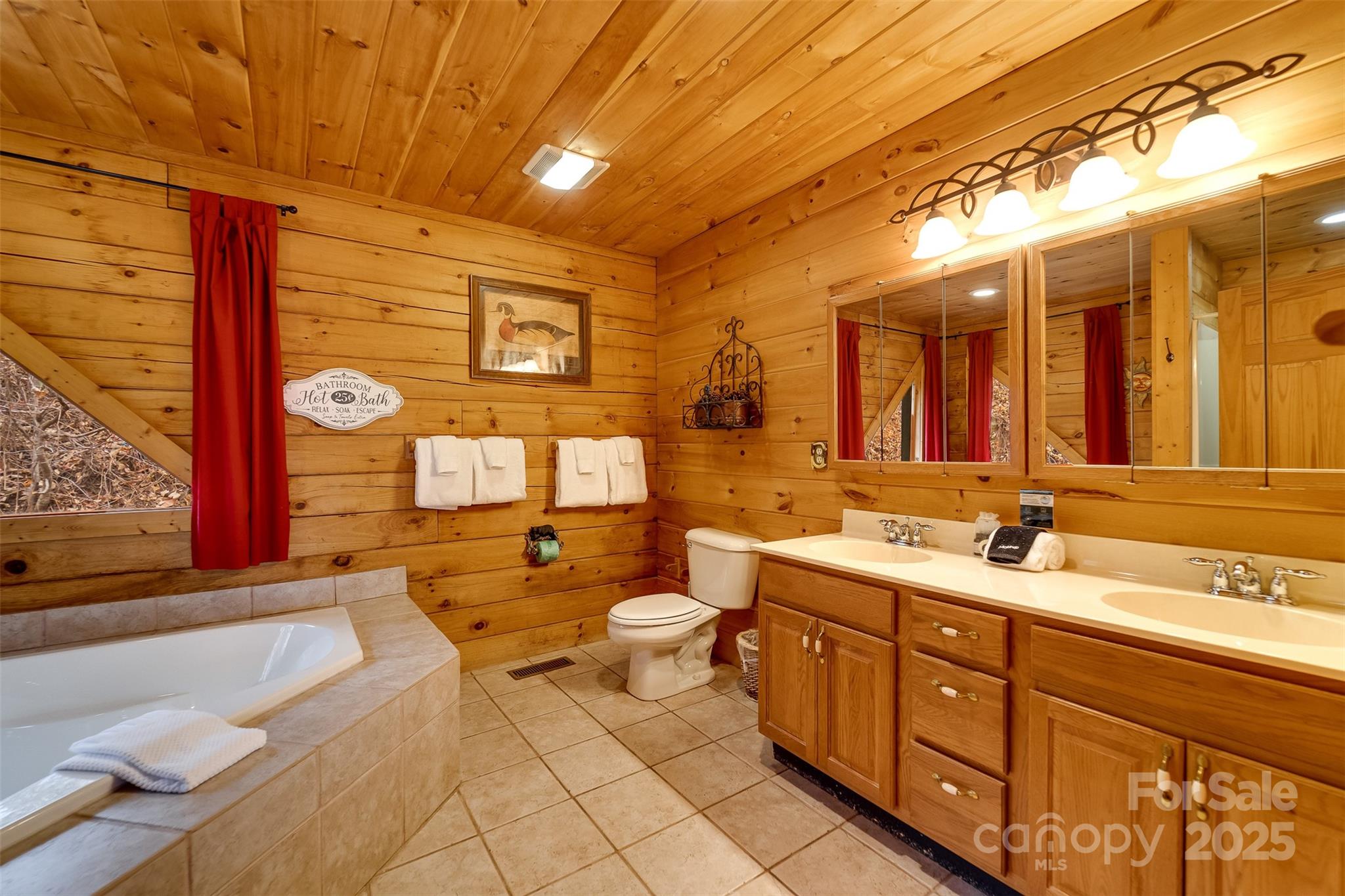 561 Signal Ridge Sylva, NC 28779 - Photo 21 of 48 a spacious bathroom with a double vanity sink and a mirror