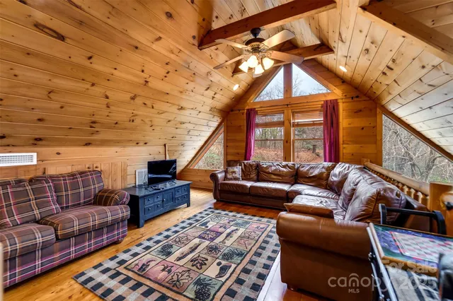 a living room with furniture a rug and a window