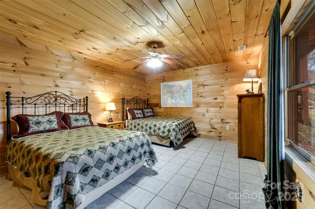 a bedroom with double bed and a window