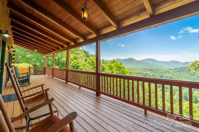 a view of a balcony with chairs and wooden floor
