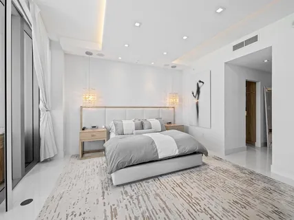 a bedroom with a bed and a large mirror