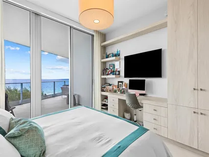 a room with a bed and a flat screen tv