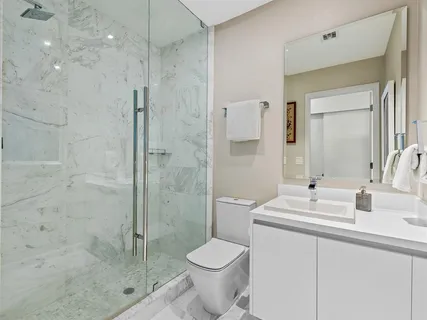 a bathroom with a sink toilet and shower