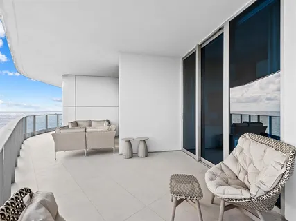 a living room with furniture and floor to ceiling window