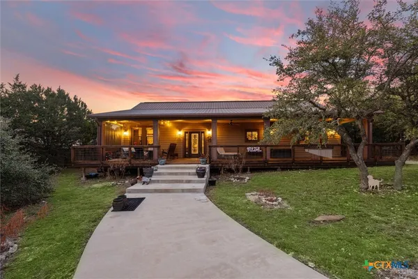 a view of a house with backyard porch and sitting area