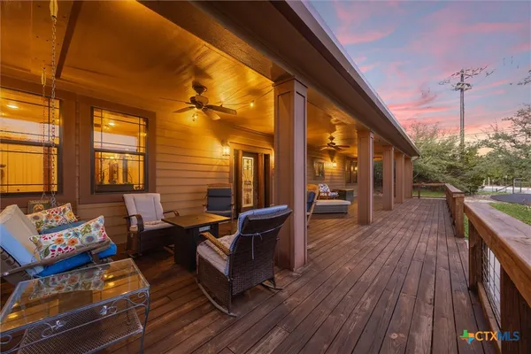 a balcony with furniture and wooden floor