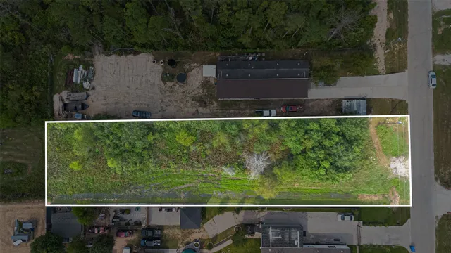 an aerial view of a house with a yard lake and outdoor seating