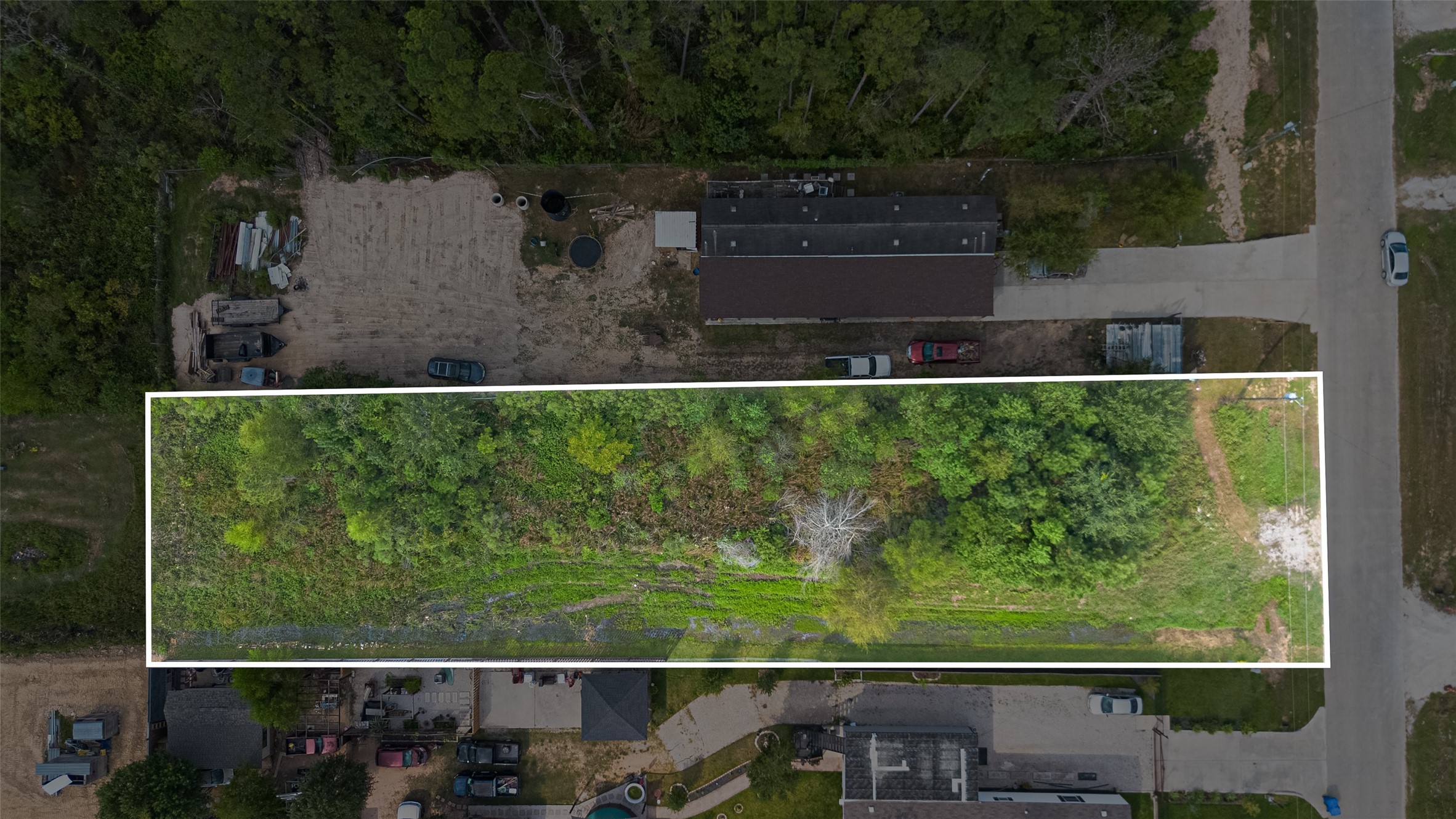 128 County Road 3548 Cleveland, TX 77327 - Photo 2 of 3 an aerial view of a house with a yard lake and outdoor seating