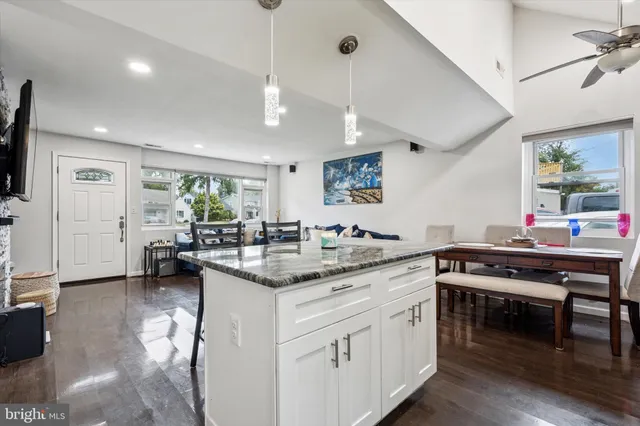 a kitchen with a sink cabinets and wooden floor